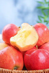 Fresh Red Fuji Apples from Xinjiang China with Bite Taken - Healthy Organic Fruit in Wicker Basket