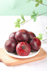 Fresh Thai Mangosteen Tropical Fruit on Wooden Board with Natural Green Background