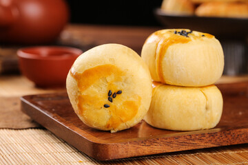 Handmade Chinese Mooncakes with Bean Paste Filling on Wooden Board - Traditional Asian Desserts for Mid-Autumn Festival