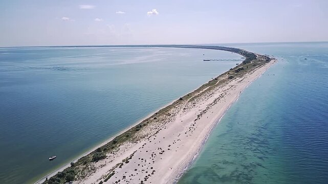 A Gentle Seashore With A Sandy Spit Stretching Into The Distance.