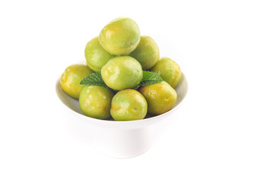 Fresh Green Apricots and Pears in White Bowl with Mint Leaf Garnish