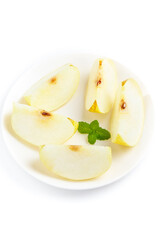 Fresh Sliced Dangshan Pears on White Plate with Mint Garnish Isolated on White Background