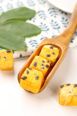 Passion Fruit Instant Tea Cubes with Dried Fruit Pieces in Wooden Spoon