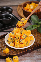 Freeze-dried passion fruit chunks instant tea snacks dried tropical fruit cubes with seeds wooden spoon serving