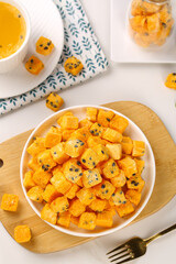 Freeze-dried passion fruit blocks with sesame seeds healthy snack bowl and herbal tea instant food arrangement