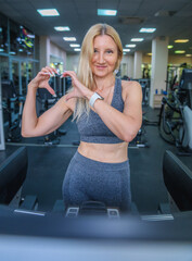 Beautiful sexy mature woman doing sports in the gym