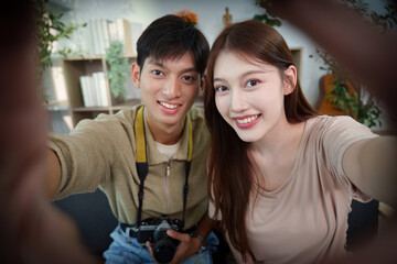 Travel Memories. Young couple taking a selfie together with a camera.