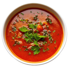 A bowl of red soup with parsley on top