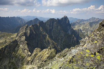 High Tatras, Slovakia,  high mountain landscape, mountains hut. Mountain landscape. European mountains Tatras mountains. Mountains tops in the clouds, blue sky. The Tatra Mountains. The tops of the mo