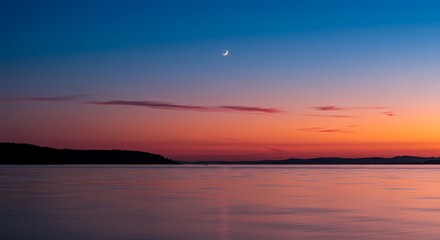Crescent Moon Over Calm Waters at Dusk