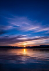 Obraz premium Serene sunset reflecting on the water's surface, a tranquil scene