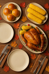 Thanksgiving dinner table flat lay with roasted turkey, corn, bread rolls and fall leaves on rustic wooden background