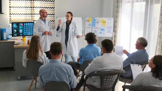 Woman in white coat with coffee gestures while promoting new medicine at hospital seminar. She argues with bald chief doctor as medical staff listen to animated discussion.