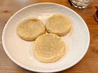 Three delicious panfried dumplings served on a white plate ready to be enjoyed for lunch or dinner