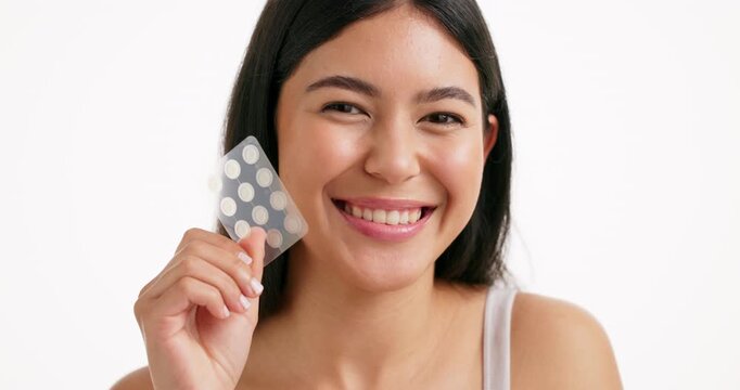 Happy woman, face or skincare with acne patches for beauty in studio on a white background. Portrait, female person or model with smile for facial healing, cosmetics or hydrocolloid stickers on space