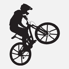 Fototapeta premium Black silhouette of cyclist performing a wheelie bicycle