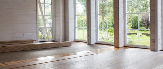 Eco friendly interior with wooden floor installation, natural materials, panoramic windows, bright daylight, modern sustainable living, unfinished room, rustic wood design, home renovation in progress