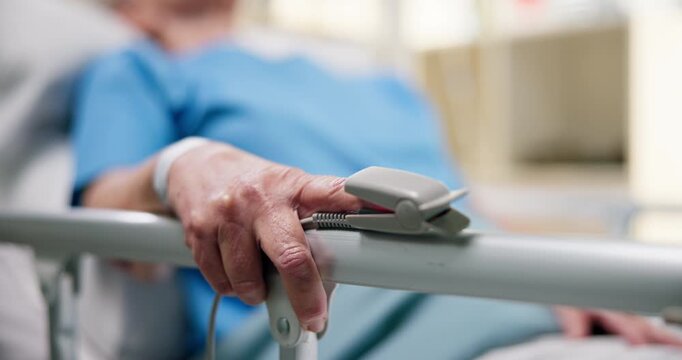 Hand, senior person and oximeter in hospital bed for blood oxygen levels, monitor pulse or recovery. Healthcare, elderly patient and medical tool in clinic to track health condition and critical care
