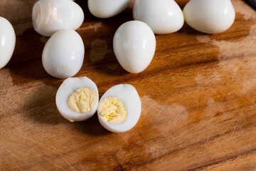 peeled boiled quail eggs on wooden board, ready to serve or cook