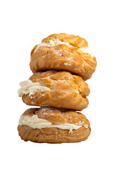 a stack of freshly baked choux pastries or cream puffs, isolated on white background