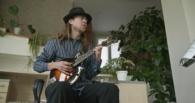 Male Musician Plays Mandolin. Caucasian Man Enjoys Playing Music 4K 10-bit