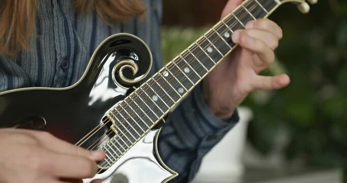Male Musician Plays Mandolin. Caucasian Man Enjoys Playing Music 4K 10-bit