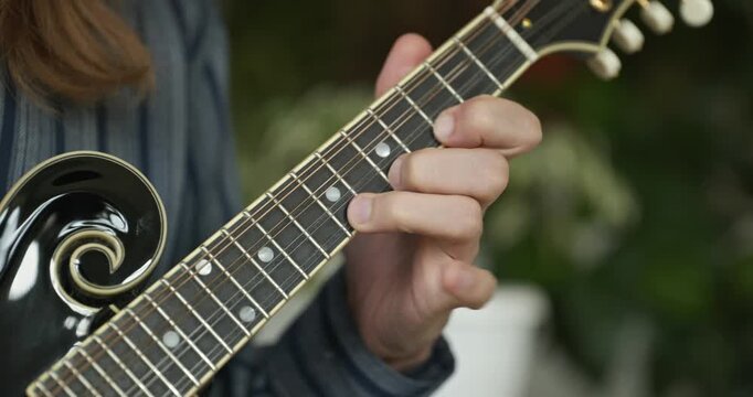 Male Musician Plays Mandolin. Caucasian Man Enjoys Playing Music 4K 10-bit