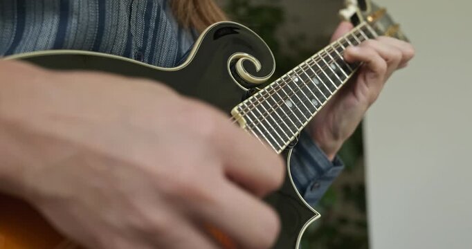 Male Musician Plays Mandolin. Caucasian Man Enjoys Playing Music 4K 10-bit