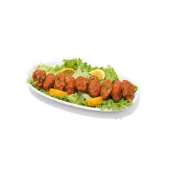 Lentil patties. Lentil patties served on a long plate. Lentil patties on a plate on a white background. Lentil patties in Turkish cuisine.
