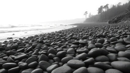 A serene black and white view of a pebble-covered beach with gentle waves lapping at the shore.