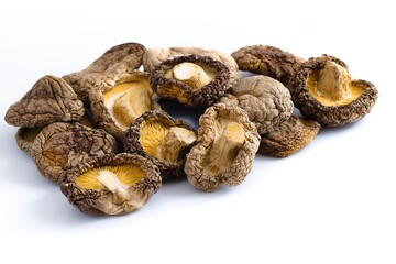 Artfully arranged dried shiitake mushrooms on white reveal rugged textures and warm, earthy tones.