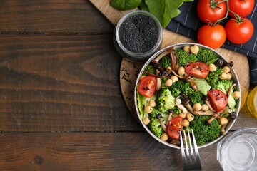 Delicious salad with shimeji mushrooms on wooden table, flat lay. Space for text