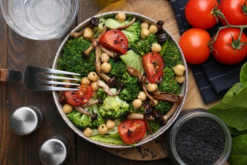 Delicious salad with shimeji mushrooms served on wooden table, flat lay