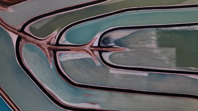 Aerial view of the evaporation ponds at Potash Road, a mesmerizing mosaic of turquoise waters separated by dark embankments, Moab, Utah, United States.
