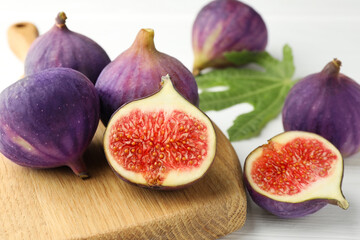 Whole and cut figs on table, closeup