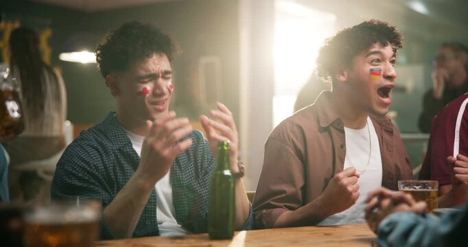 Men, friends and celebration with goal at sports bar with flag for football rival, derby and competition. People, happy and sad with cheers, fist pump or stress for European league in crowd at pub