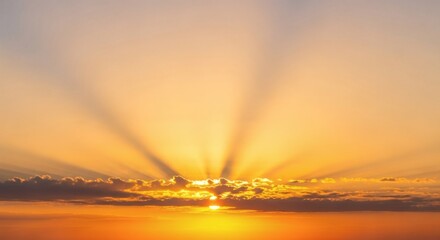 Sunbeams fan out from behind clouds during a vibrant sunset