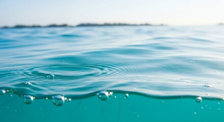 Underwater view of clear turquoise water with ripples and air bubbles