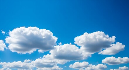White cumulus clouds drift across a bright blue sky