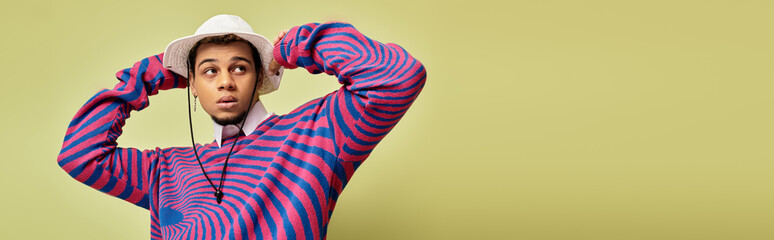 Stylish young Black man models trendy sweatshirt with a bright green background