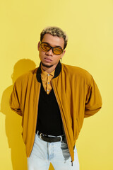 Stylish young african american man poses confidently in trendy bomber jacket