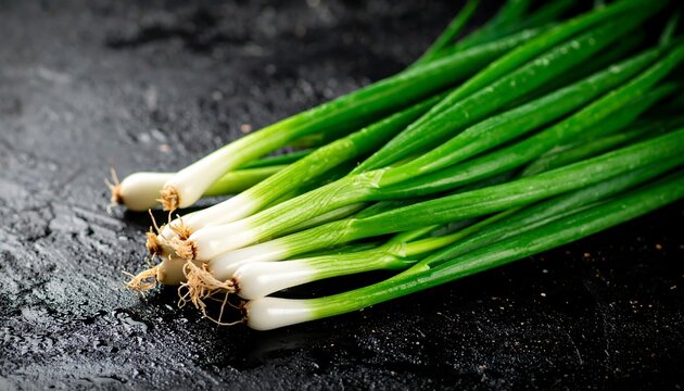 Fresh green onions on dark surface - Powered by Adobe