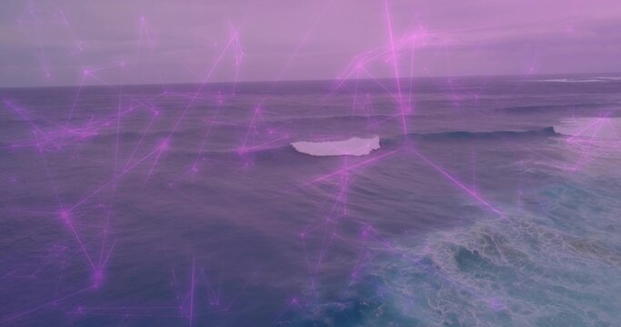 Fototapeta Showing expansive ocean surface rolling at sea, with white foam and purple network lines