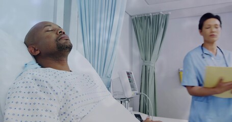 Lying patient in ward with iv tubing, nurse wearing scrubs walking holding patient file, copy space