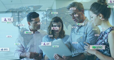 Four colleagues analyzing metrics on laptop in meeting room, with world map, floating social icons