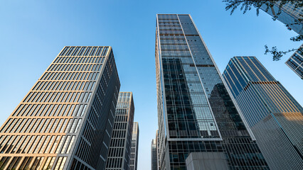 Obraz premium Modern skyscrapers in an urban business district under a clear blue sky