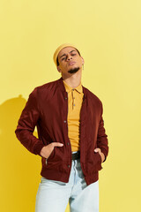 Stylish young african american man showcases fashion in bright studio setting