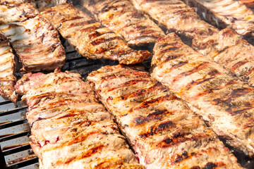 A close up of pork ribs cooking on a barbecue grill, Grilled Meat