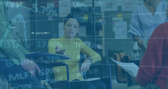Woman in wheelchair wearing yellow top sharing documents in meeting room, with glass partition