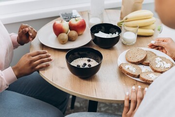 Two black women having healthy breakfast at home